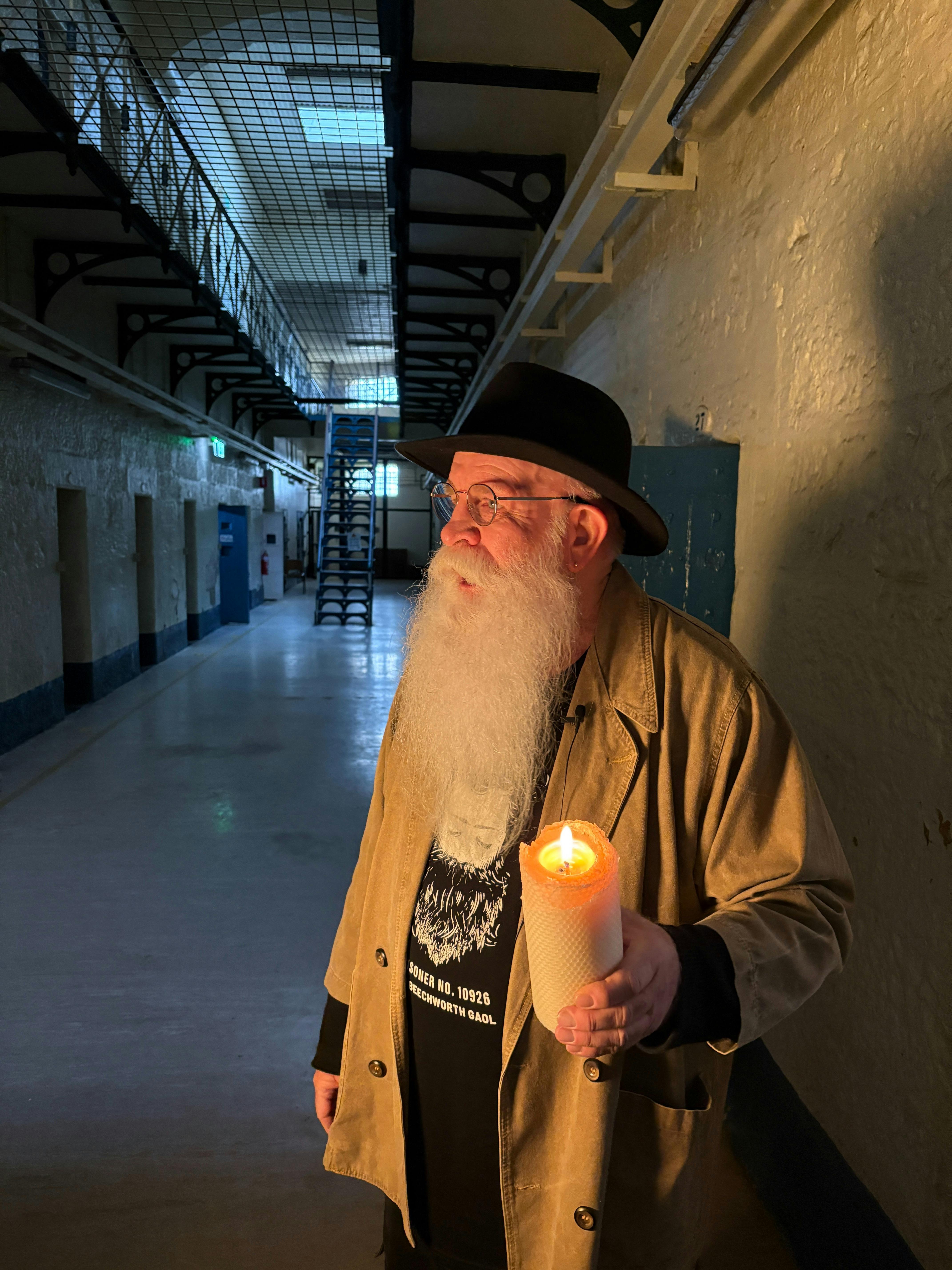Man holding candle in the cell blocks
