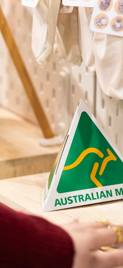 Australian Made green and gold logo on a stall at the market