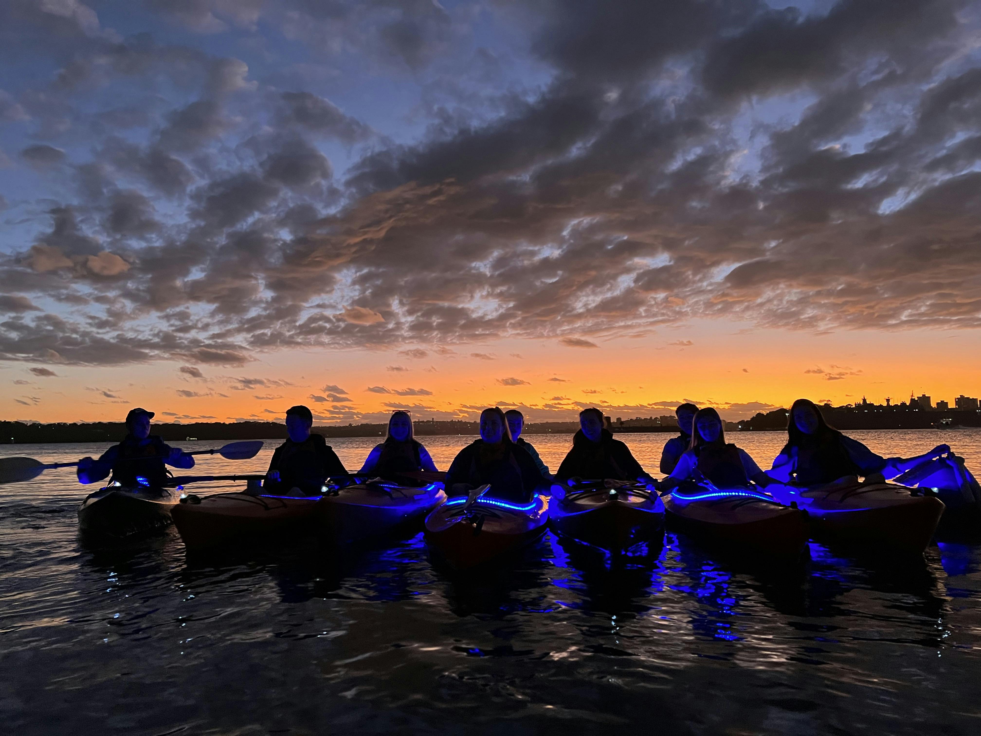 kayakers lining up at the golden glow of the sunrise