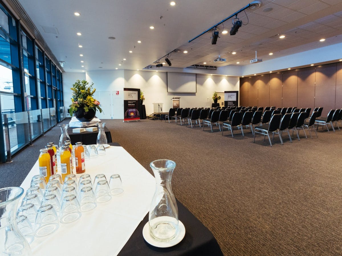 Function Room set theatre style with projector and screen, floor to ceiling  windows.