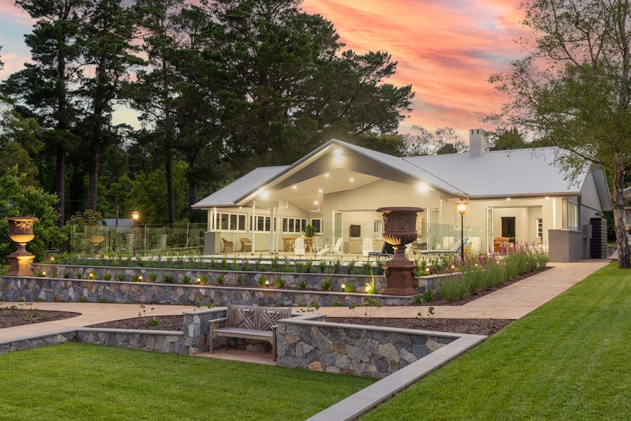 A luxury property is lit up at dusk