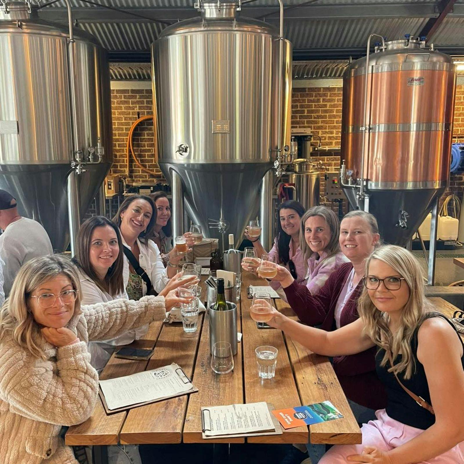 ladies on a tour in front of vats