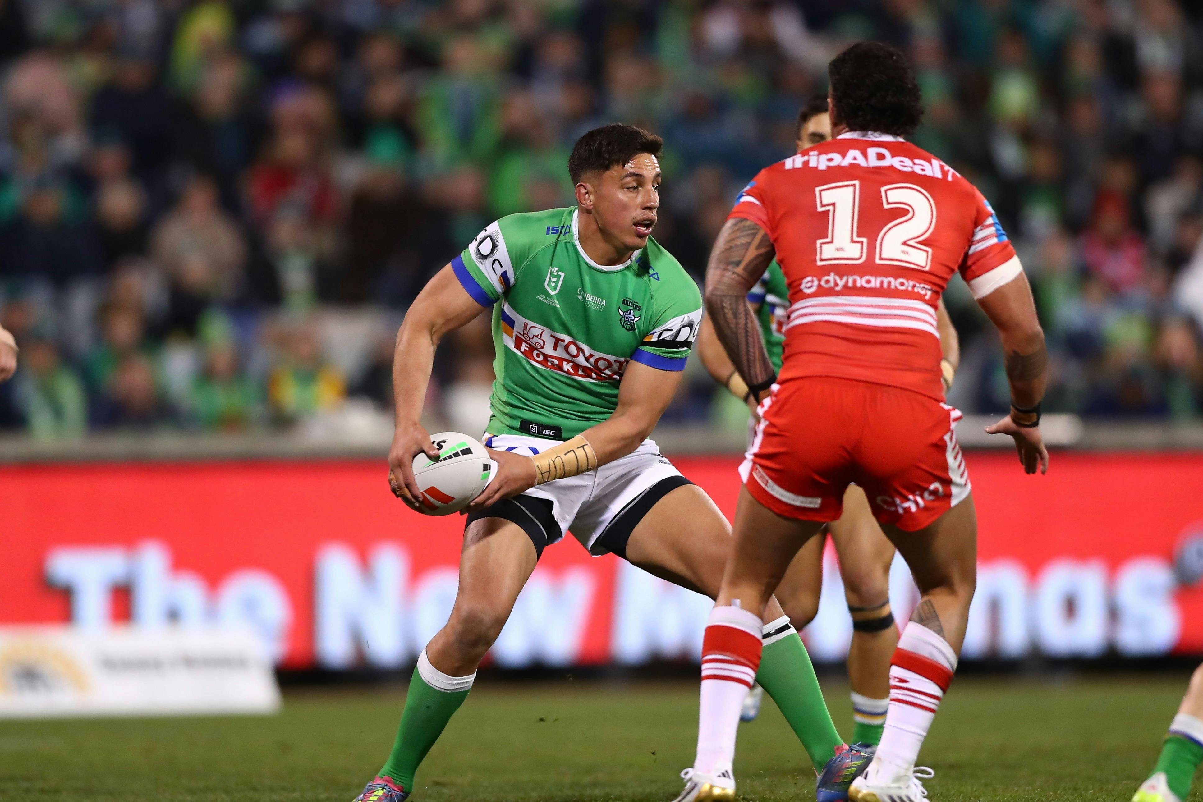 Canberra Raiders player Joseph Tapine passing the ball.