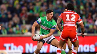 Canberra Raiders player Joseph Tapine passing the ball.