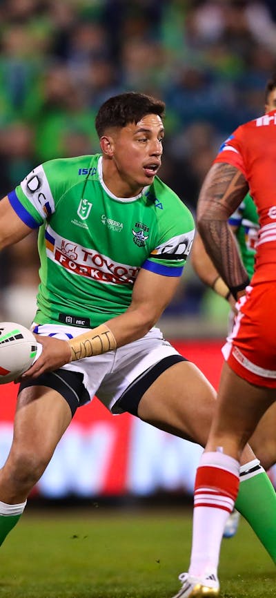 Canberra Raiders player Joseph Tapine passing the ball.