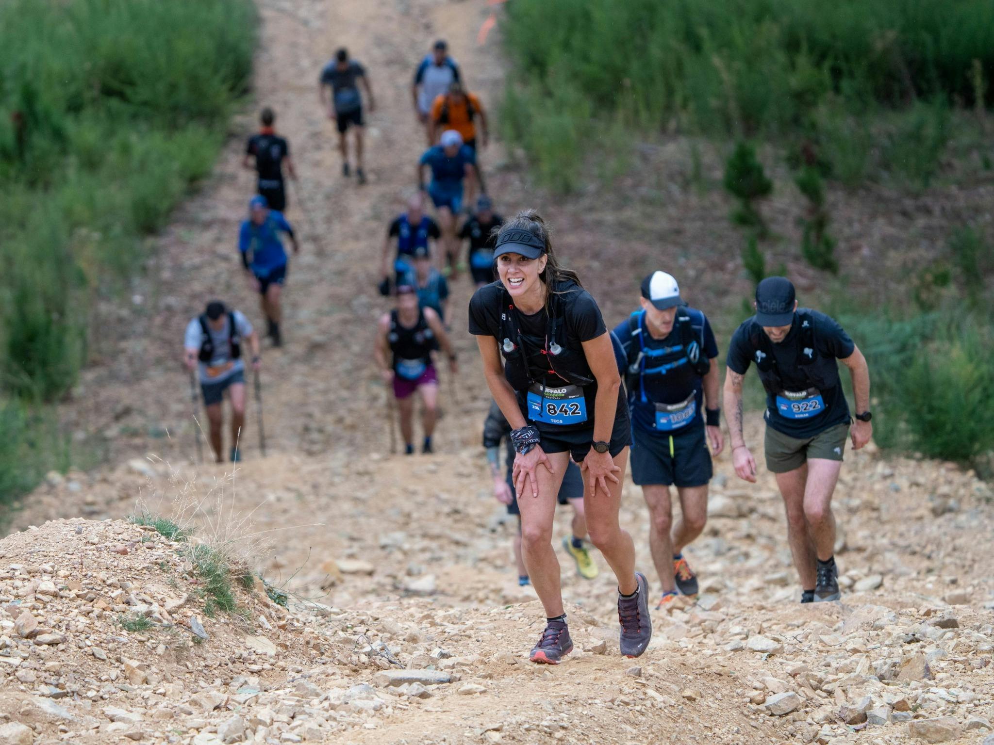 Group of people running uphill.