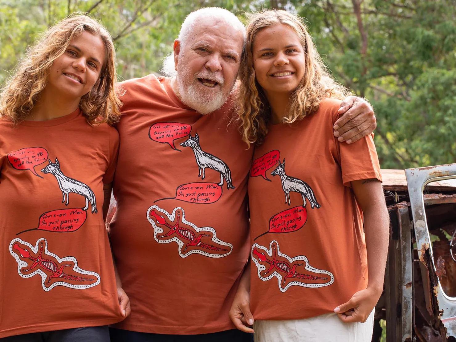 2 young twins either side of our elder all wearing his shirt with a white dog and a red crocodile