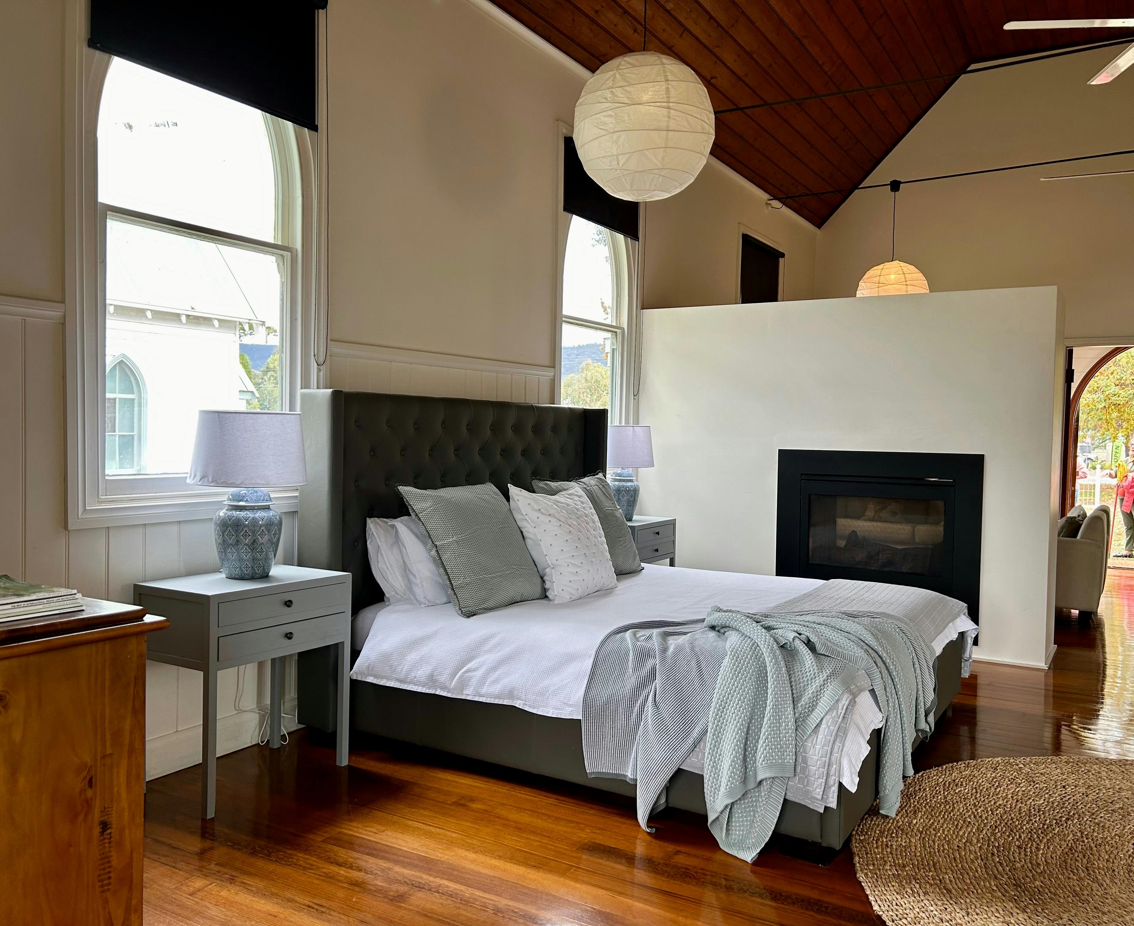 King size bed with gas log fire in the background