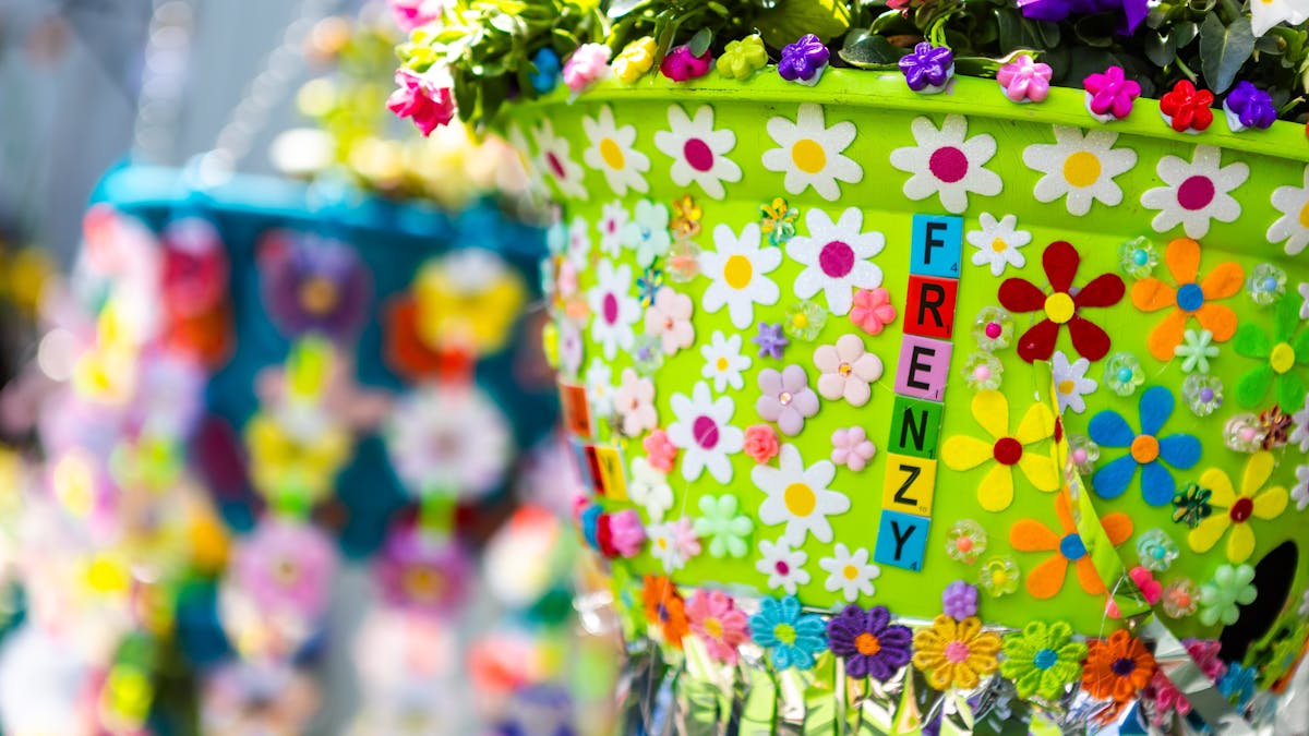 Green hanging flower basket with flower stickers and "FRENZY" spelled out on pot. Green hanging flower basket with flower stickers and "FRENZY" spelled out on pot.