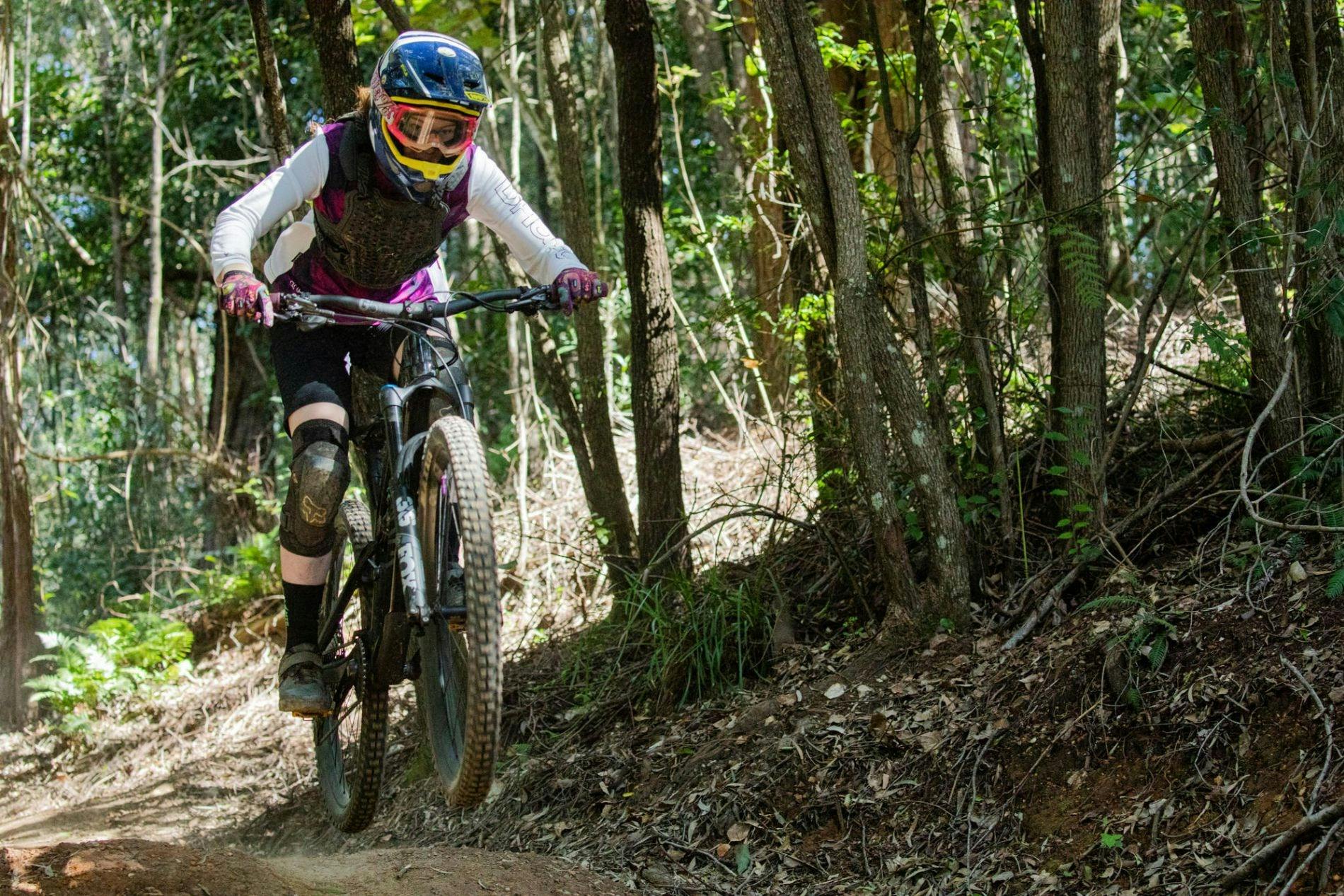 rider in safety gear jumping on mountain bike