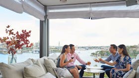 Couples enjoying drinks with Harbour views at Henry Deane