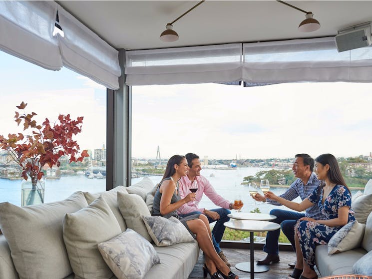 Couples enjoying drinks with Harbour views at Henry Deane