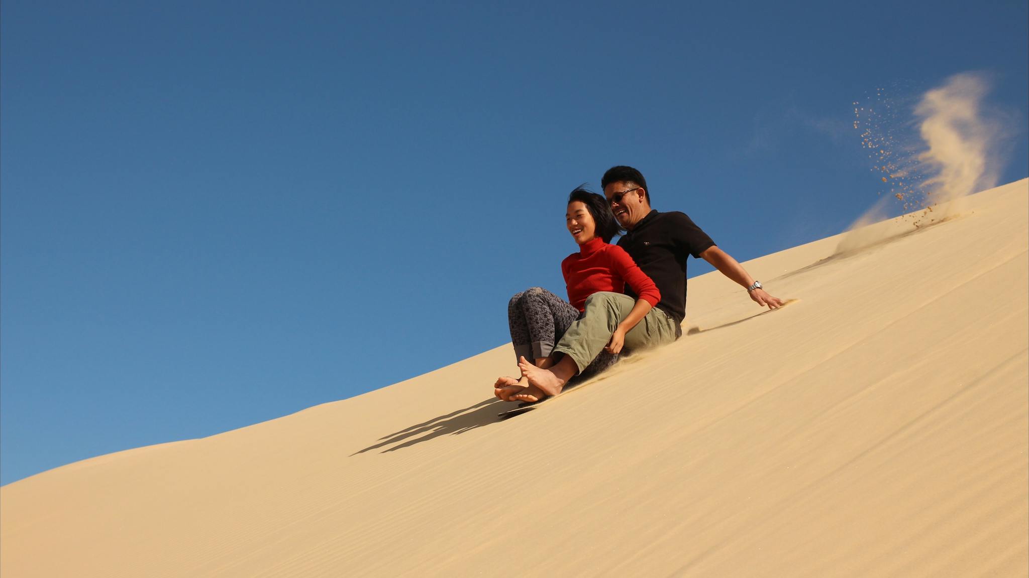 Tandem ride down the high dune