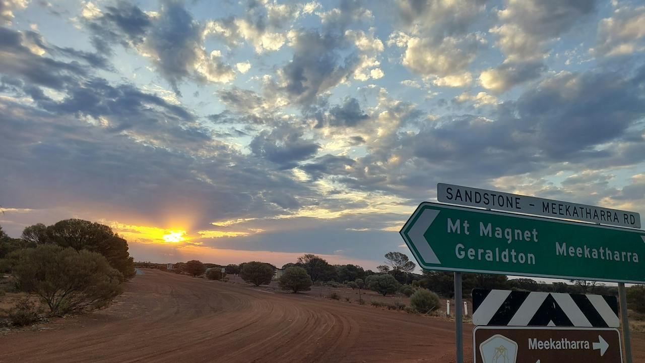 sunset behind sign