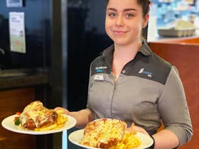 Female waitress serving bistro meals