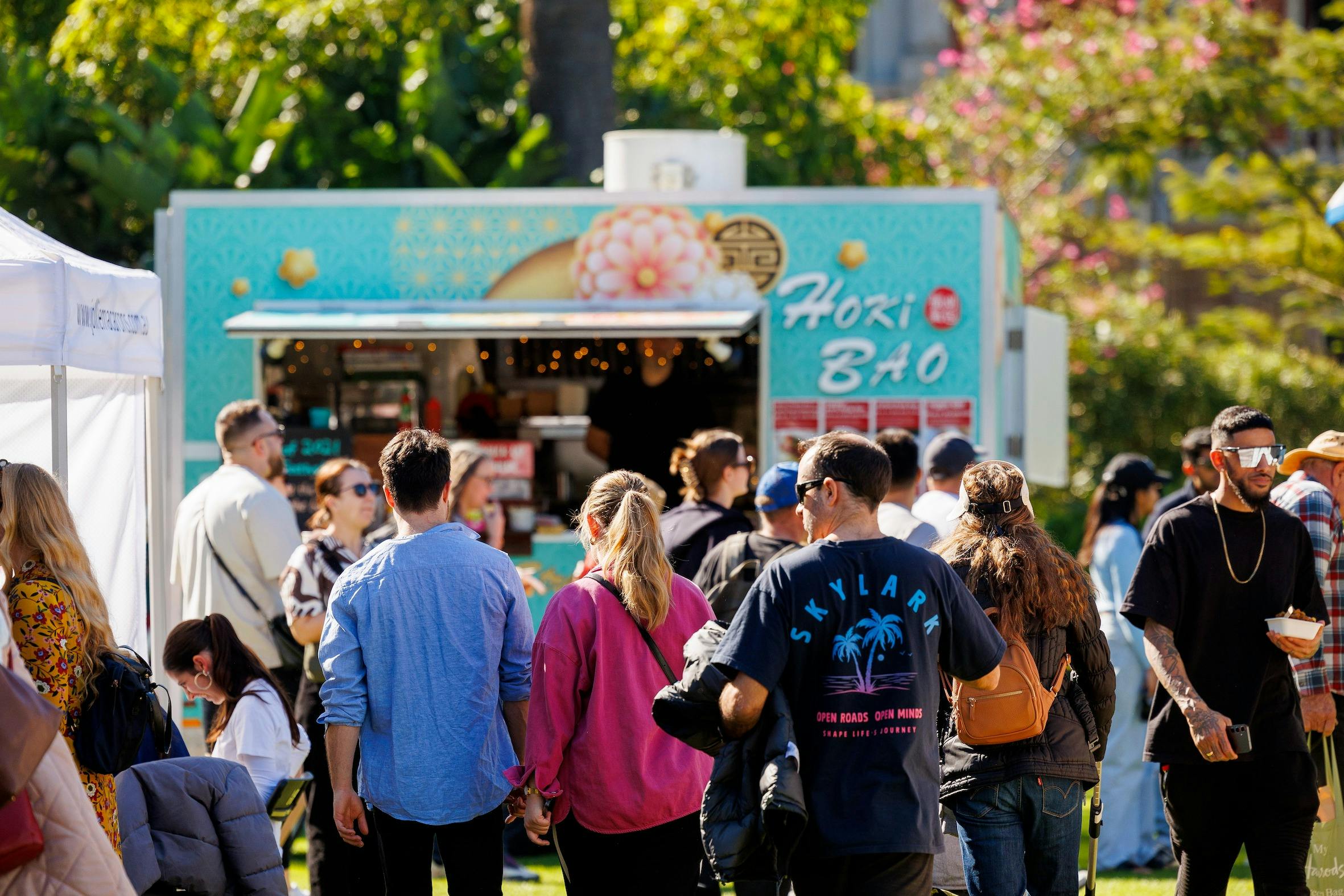 People in a crowd in front of a food truck