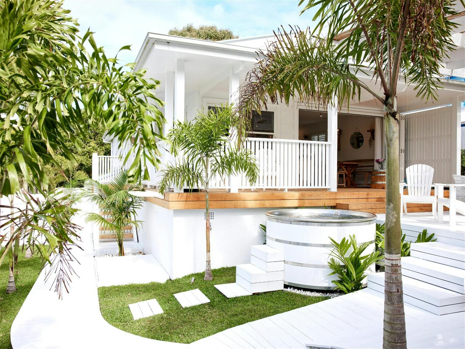 BBQ and entertain outdoors overlooking the white timber hot tub and gated lawns