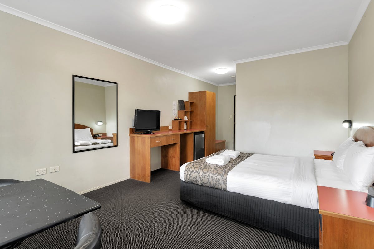 Deluxe Queen Suite has Queen Bed, dining area, AC and all modern features of a 4 Star Property