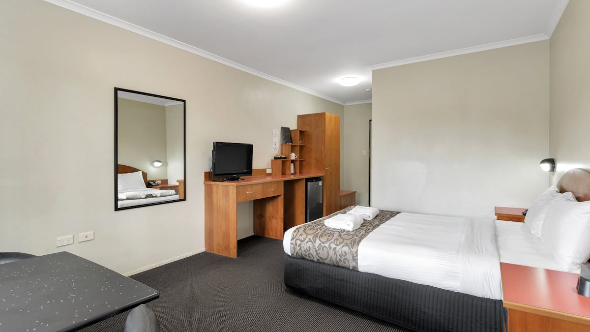 Deluxe Queen Suite has Queen Bed, dining area, AC and all modern features of a 4 Star Property