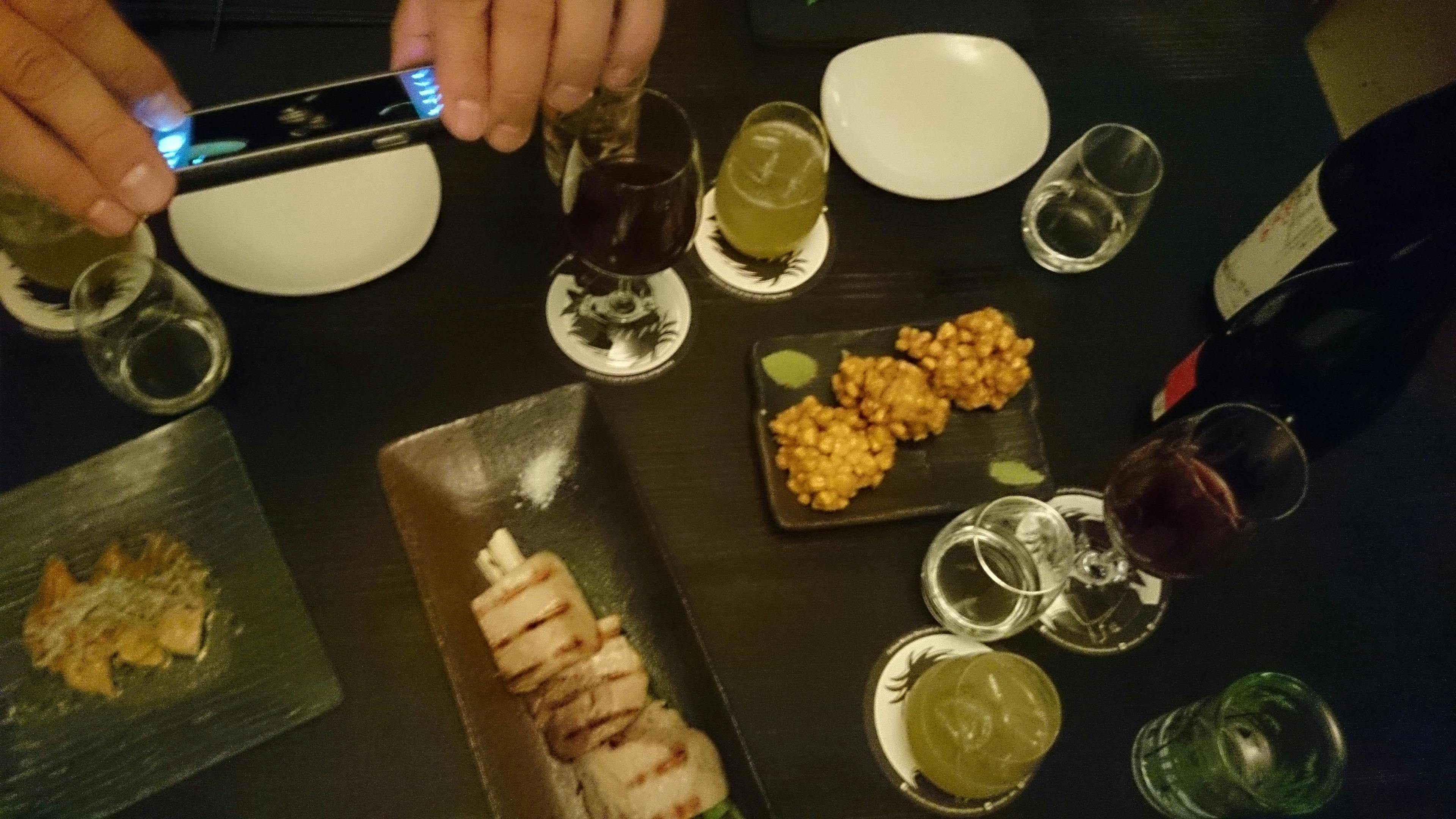 Clients taking photos as one of the tour stops, and over head image of plates of food and drink