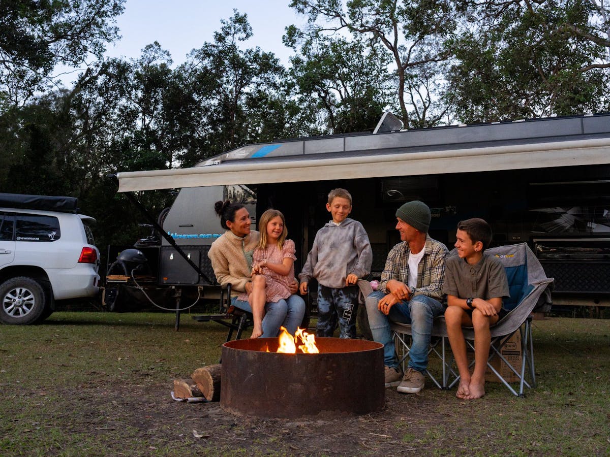 A family campsite set-up and enjoying the evening by the fire