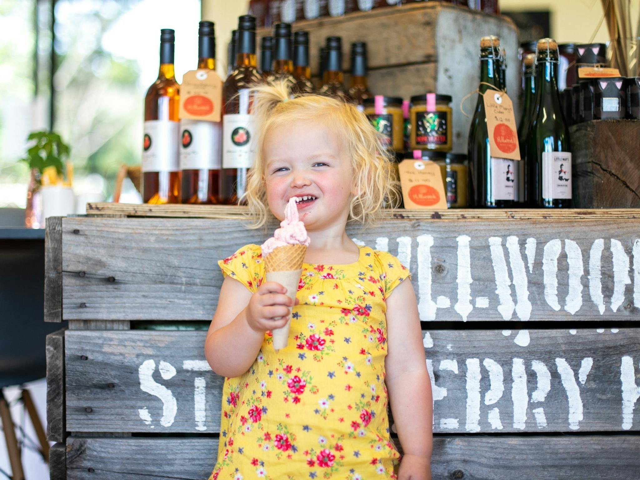 Young girl enjoying a berry ice cream in the farmgate
