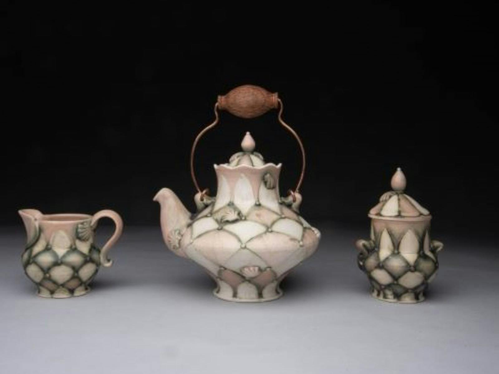 Artisan teapot with a milk jug and sugar pot