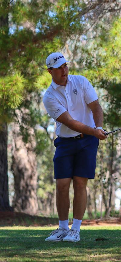 Male golfer chipping onto a green