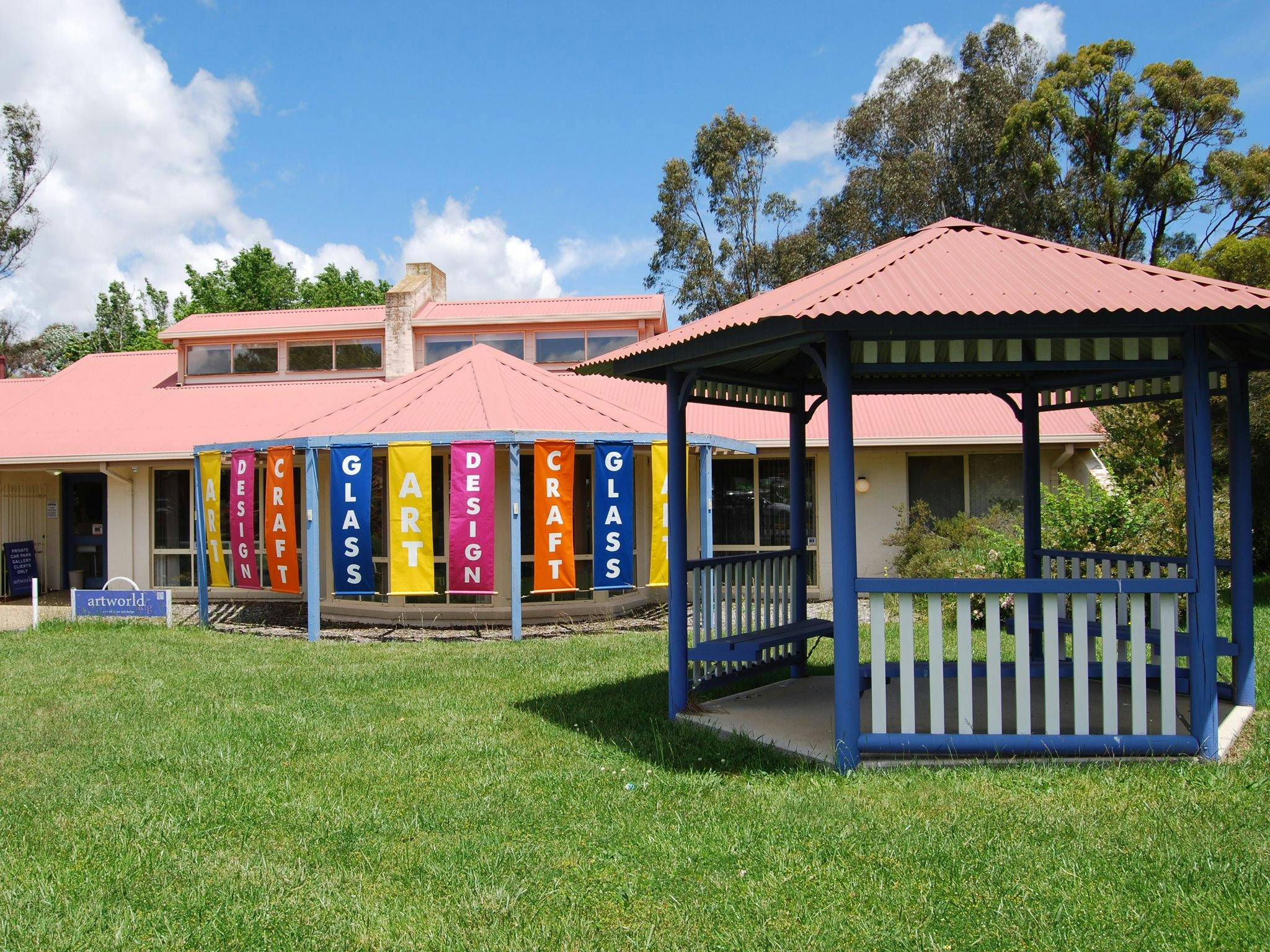 Art, Design, Craft and Glass banners at the entrance to Aboriginal Dreamings Gallery