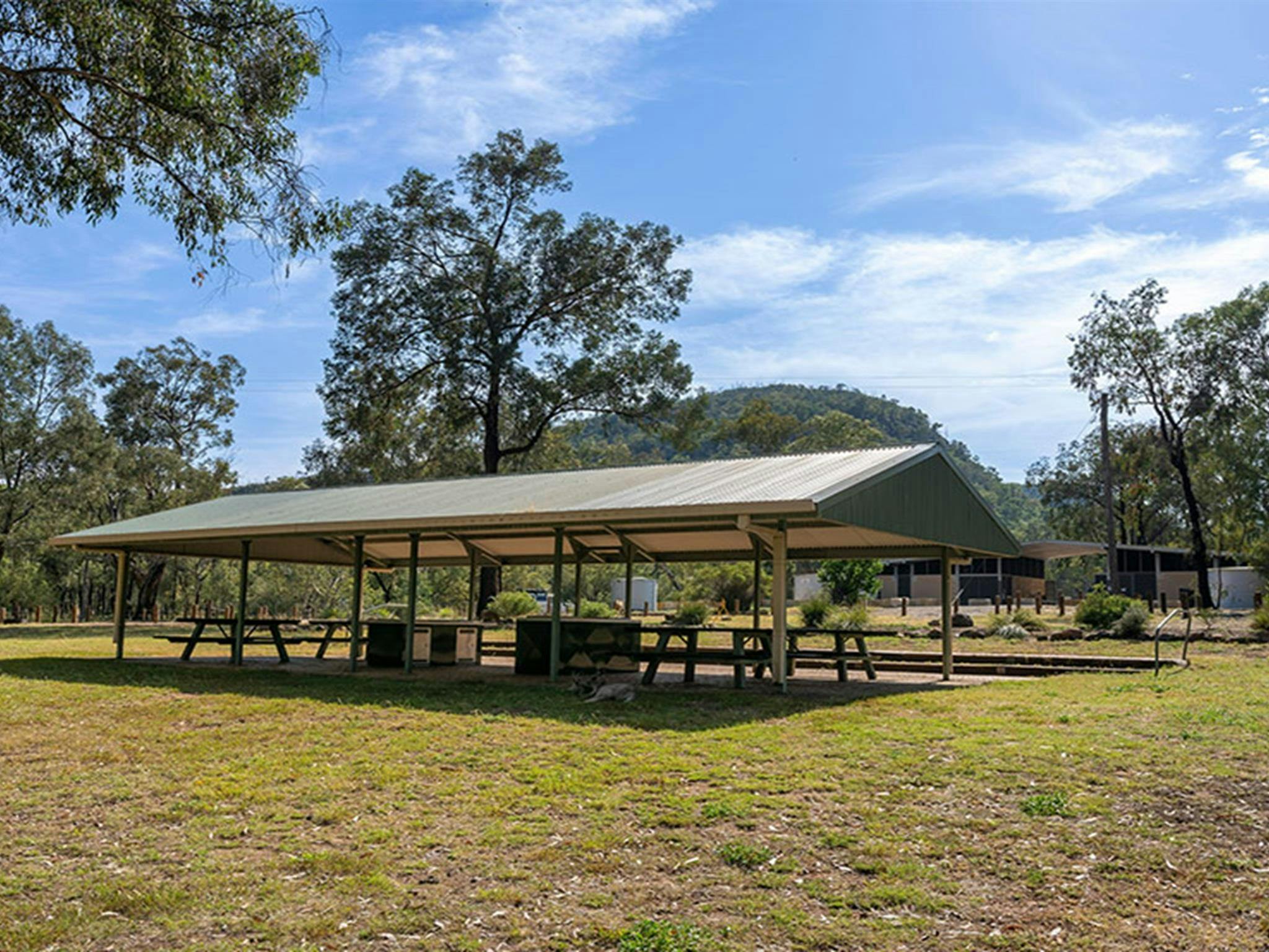 Barbecues and picnic tables under a shelter at Camp Blackman. Credit: John Spencer &copy; DCCEEW