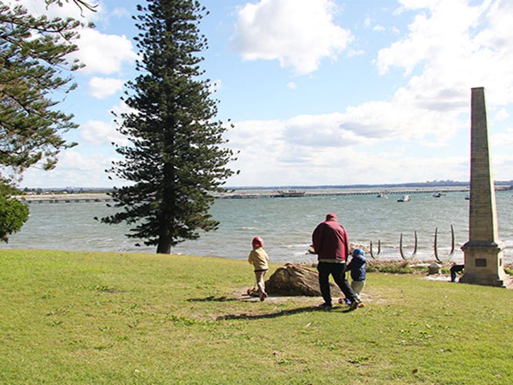 Family walking on the hill above the Captain Cook Monument. Photo credit: Natasha Webb &copy; DPIE