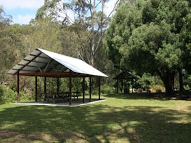A large picnic shelter next to trees at Casuarina Point picnic area in Lane Cove National Park.