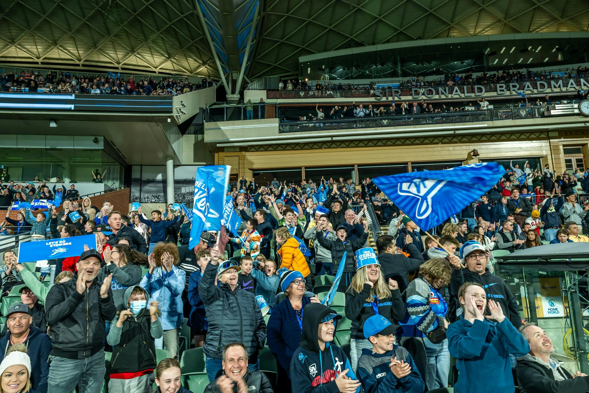 Fans cheering on the Adelaide Strikers at Adelaide Oval