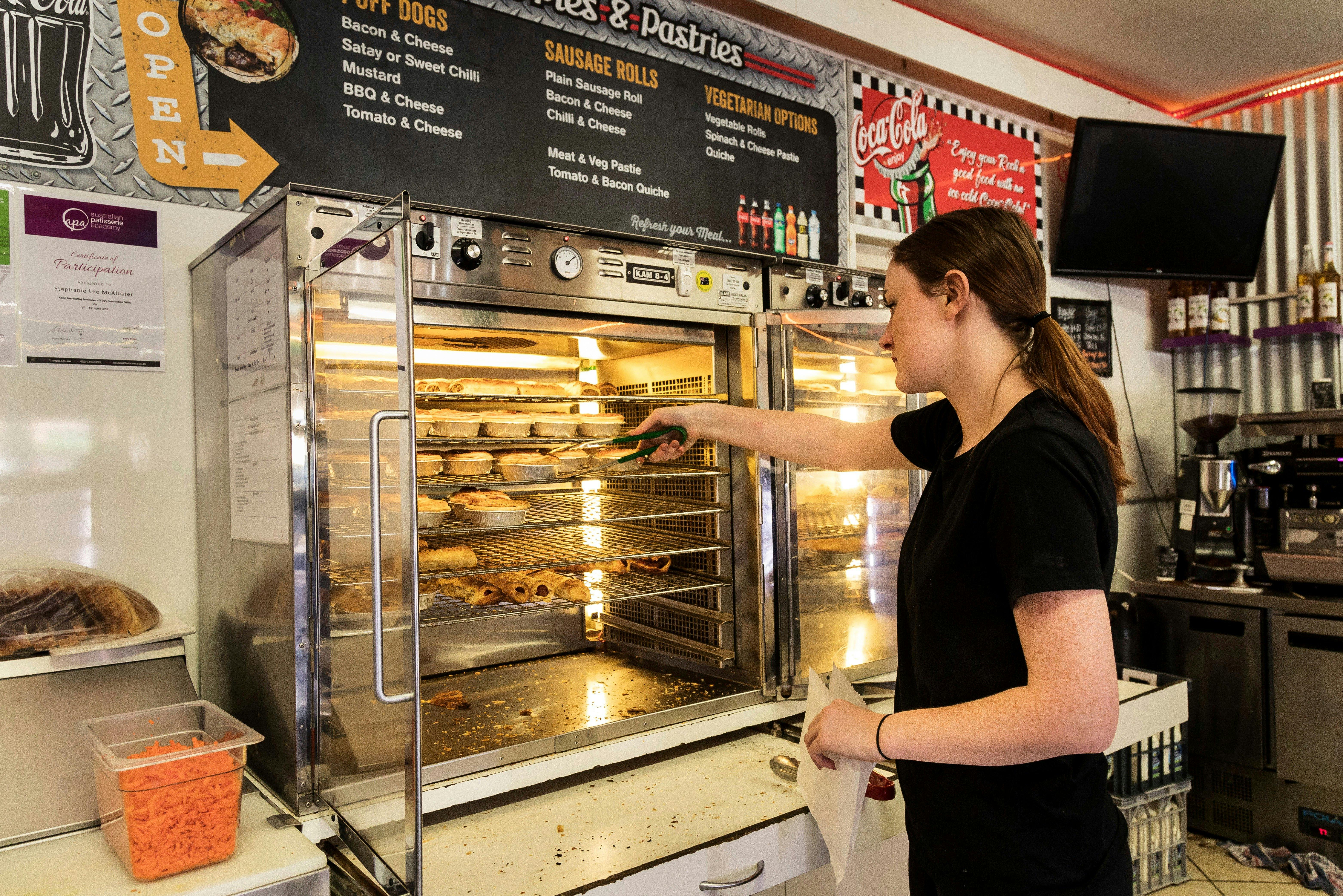Waitress serves pies at the bakery