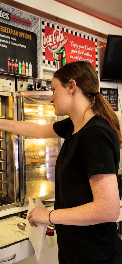 Waitress serves pies at the bakery