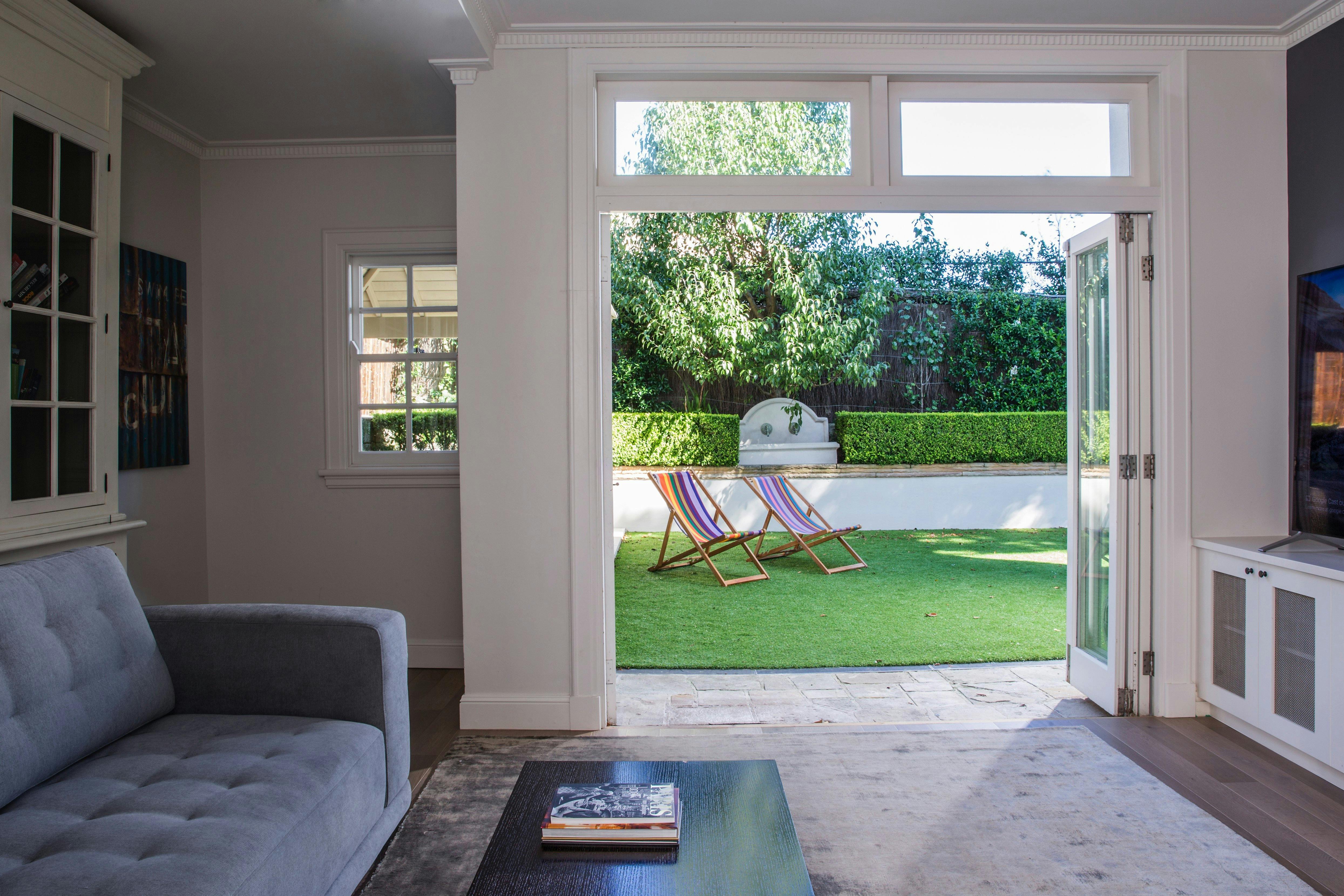 Television lounge with light from glorious French doors which open to the garden