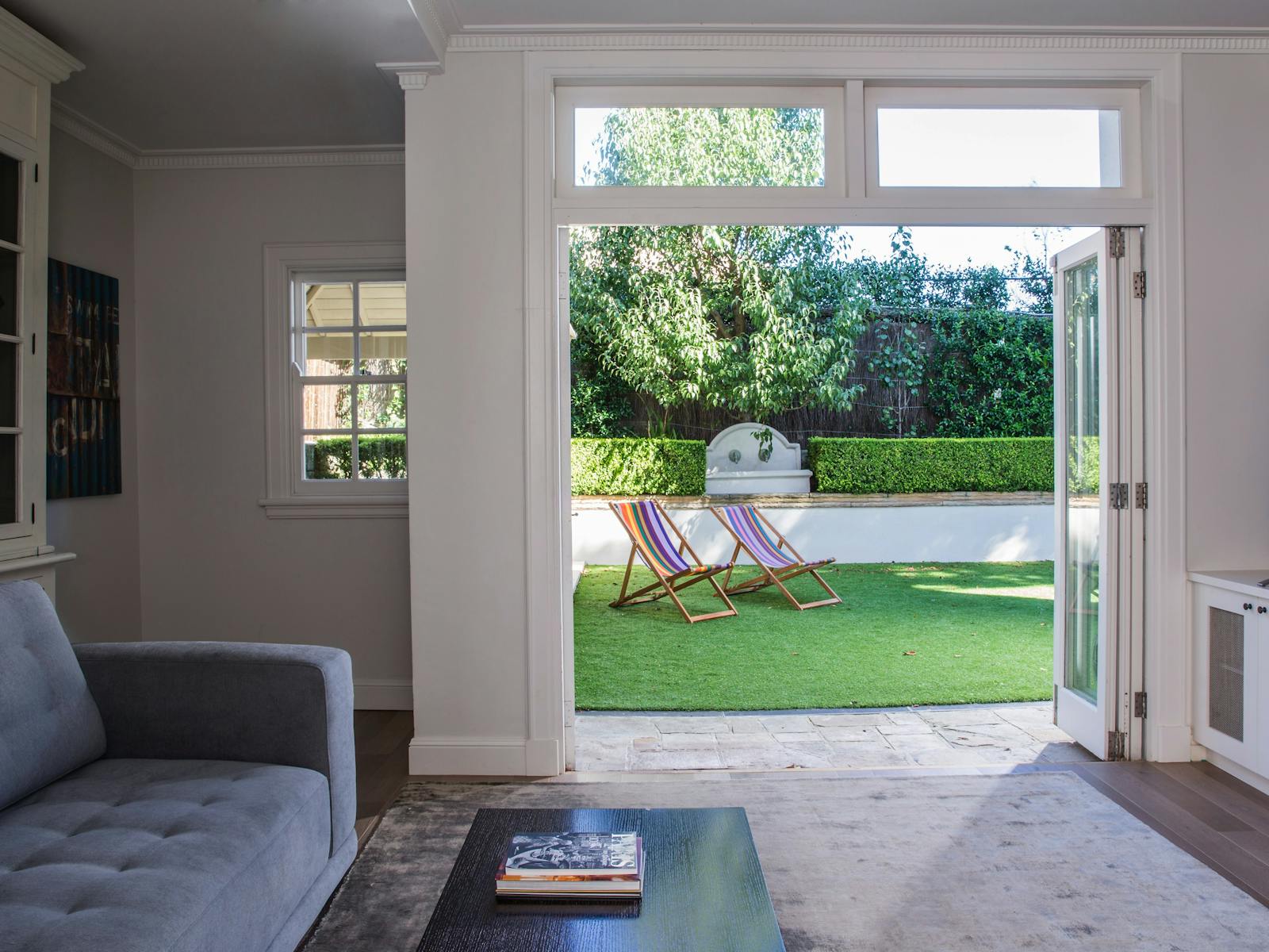 Television lounge with light from glorious French doors which open to the garden