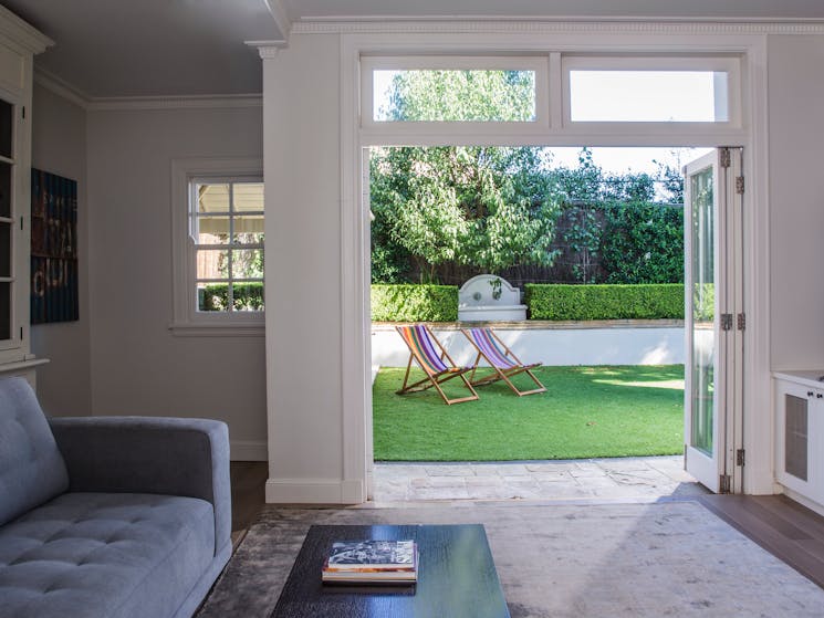Television lounge with light from glorious French doors which open to the garden