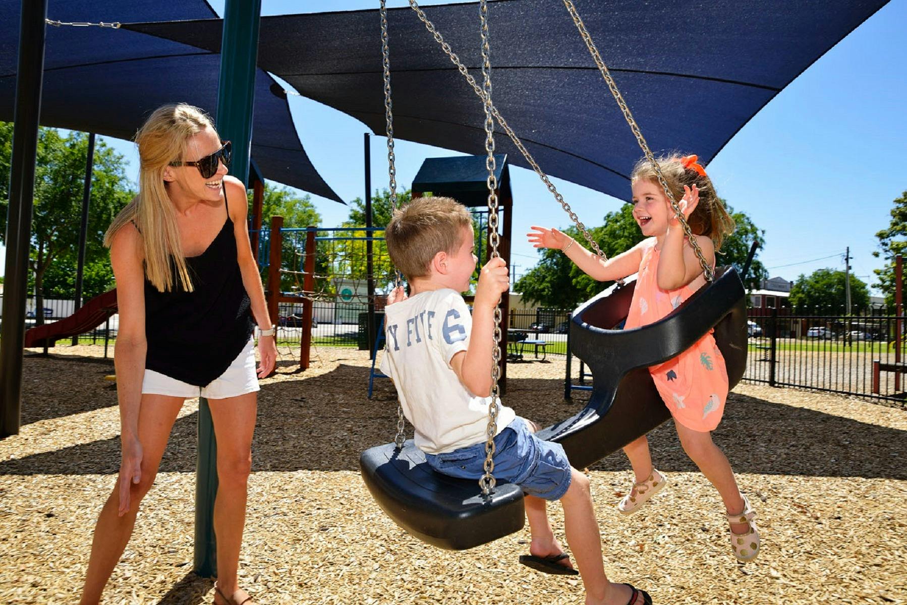 family playing on swing set