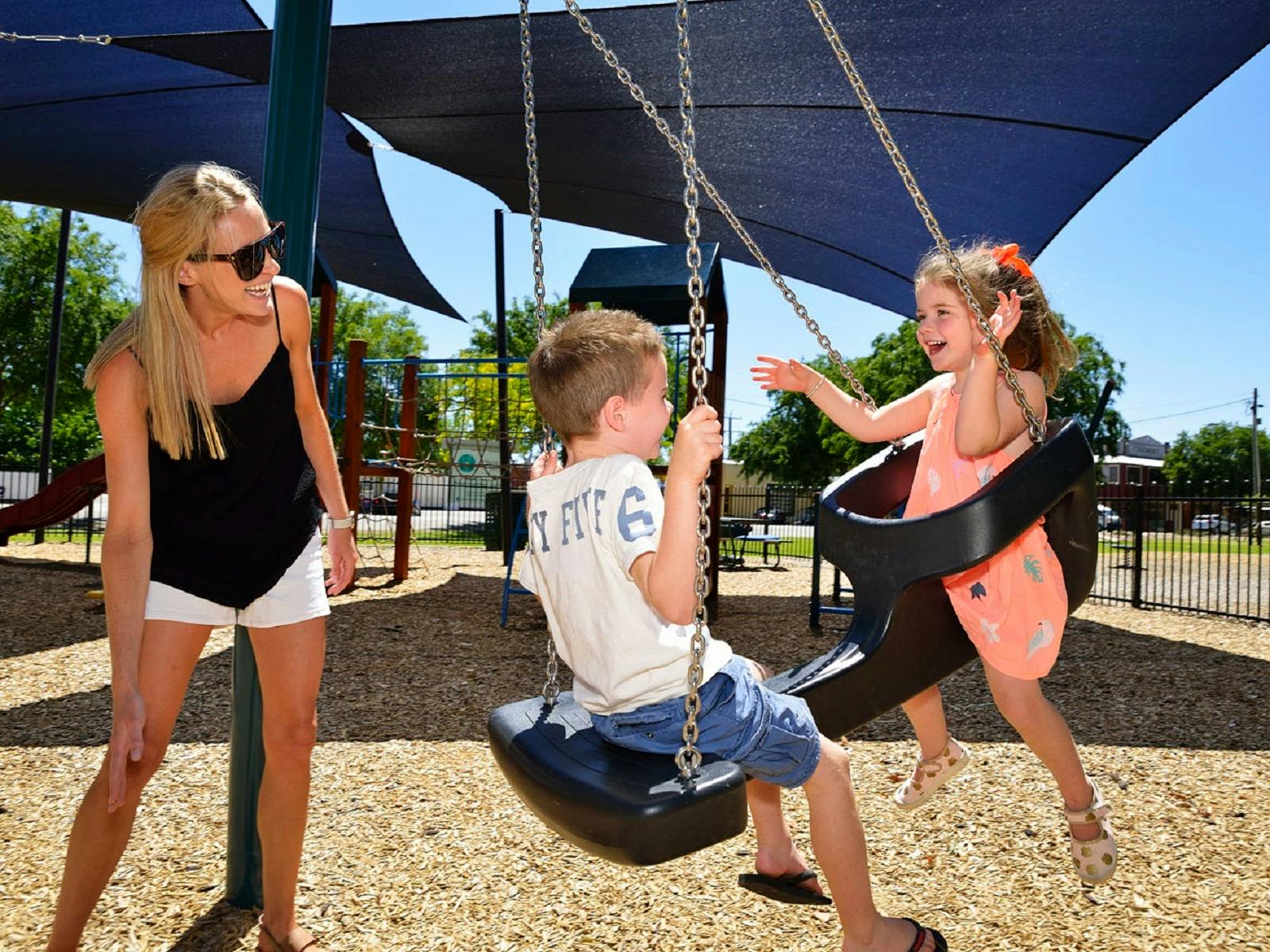 family playing on swing set