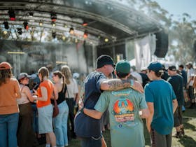 A dad and his son embracing in front of the stage at Caltowie COFU in South Australia
