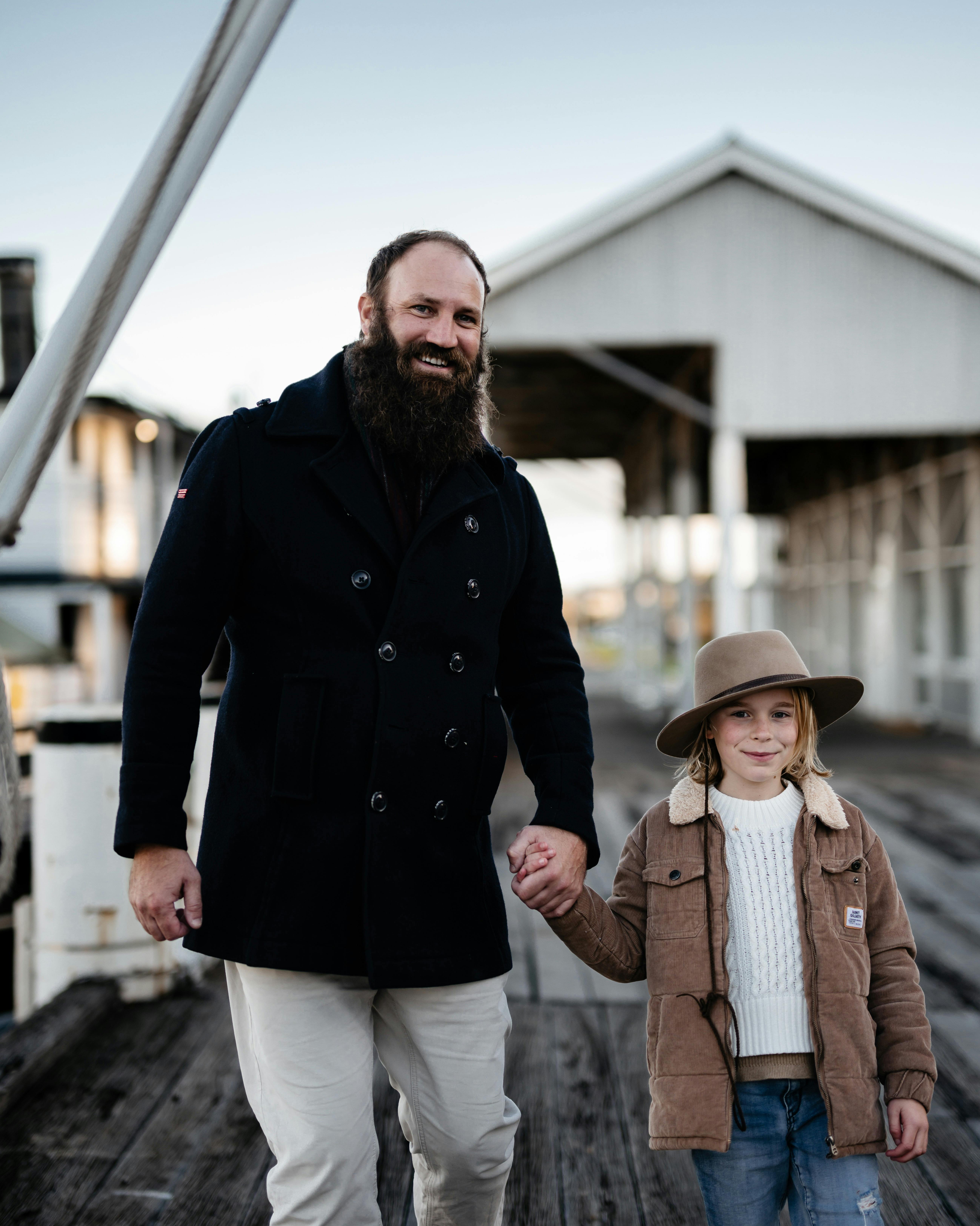 Father and child walking hand in hand on the Wharf to board our vessel