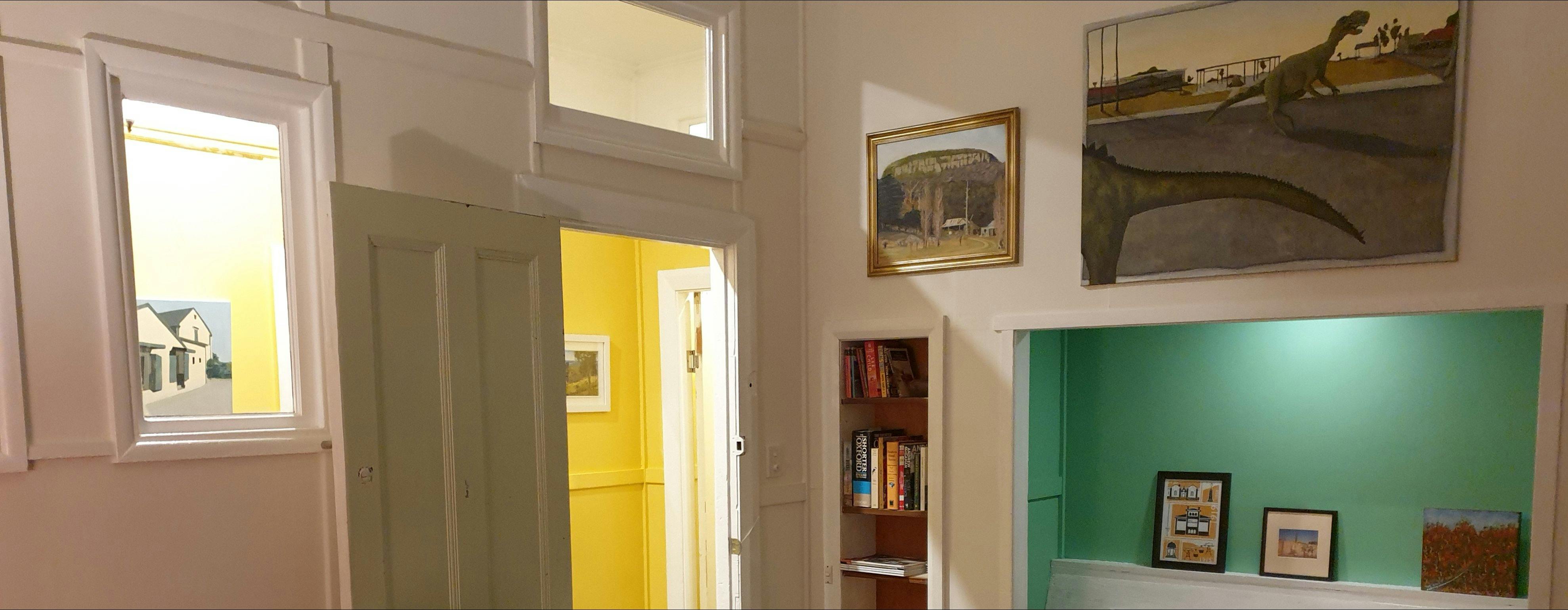 Dining room showing paintings and view through to hallway