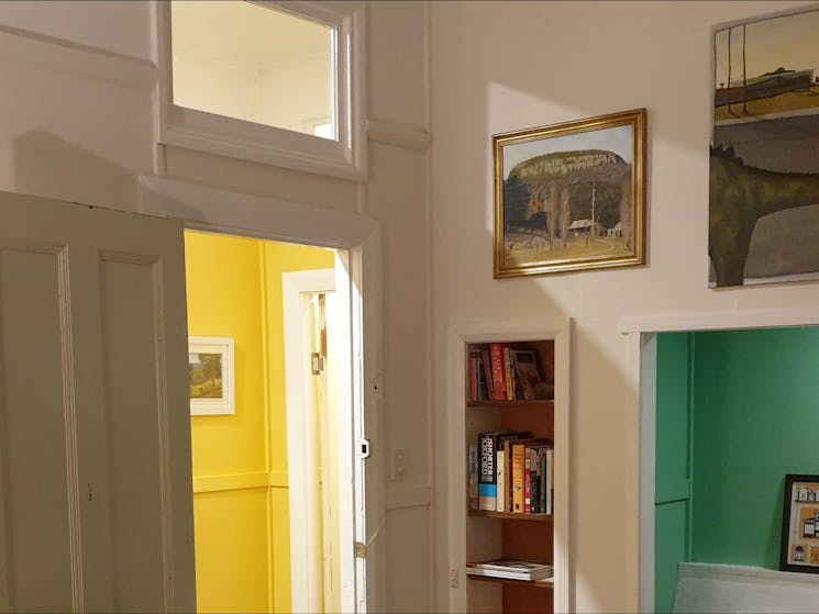 Dining room showing paintings and view through to hallway
