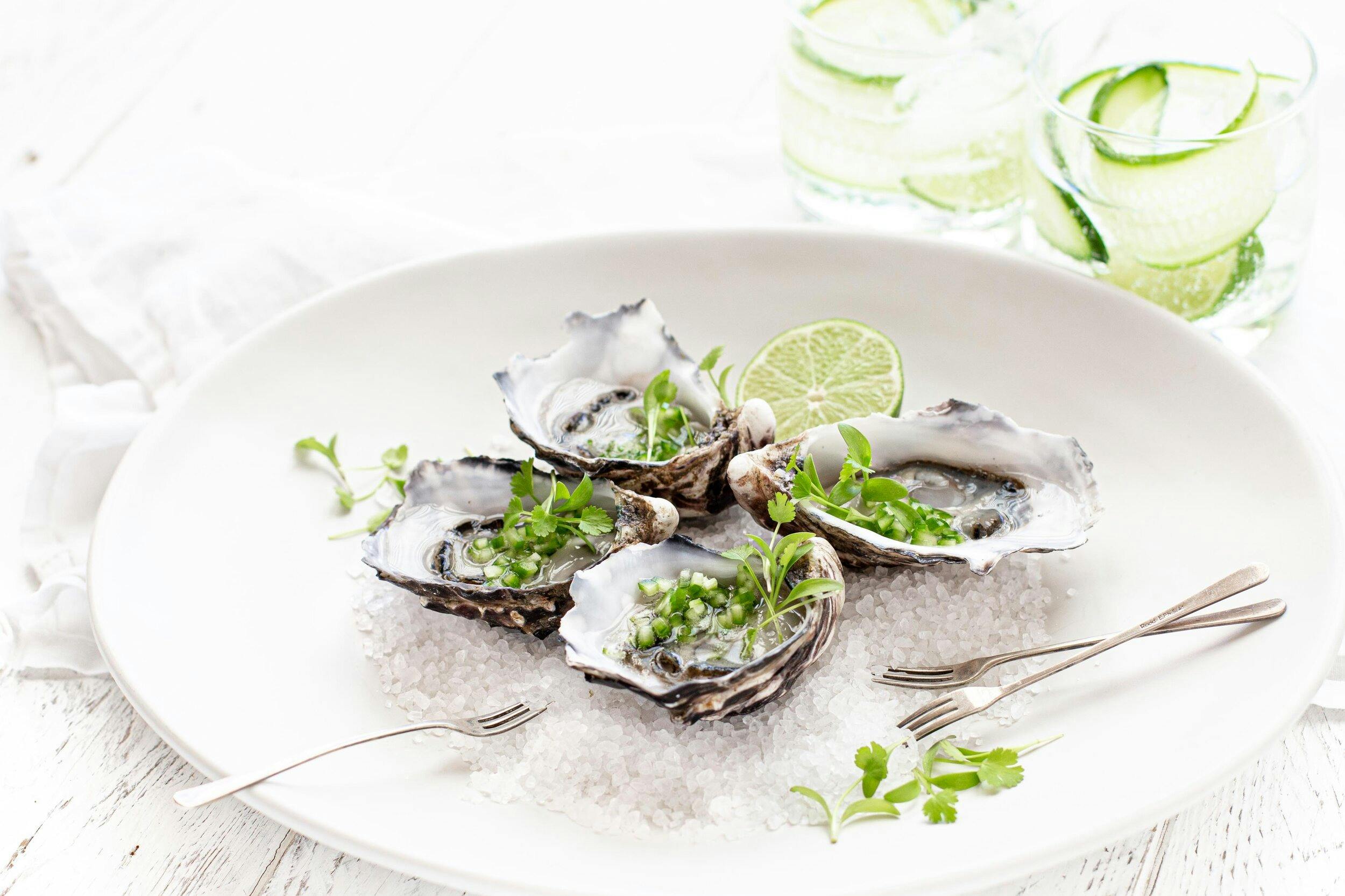 Sydney Rock Oysters with lime and herbs on EV Arcadia luxury electric charter dining