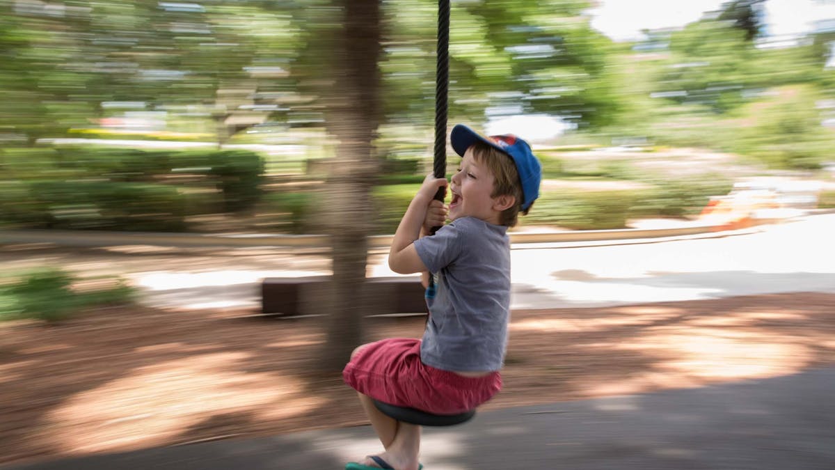 Young boy travelling down a flying fox