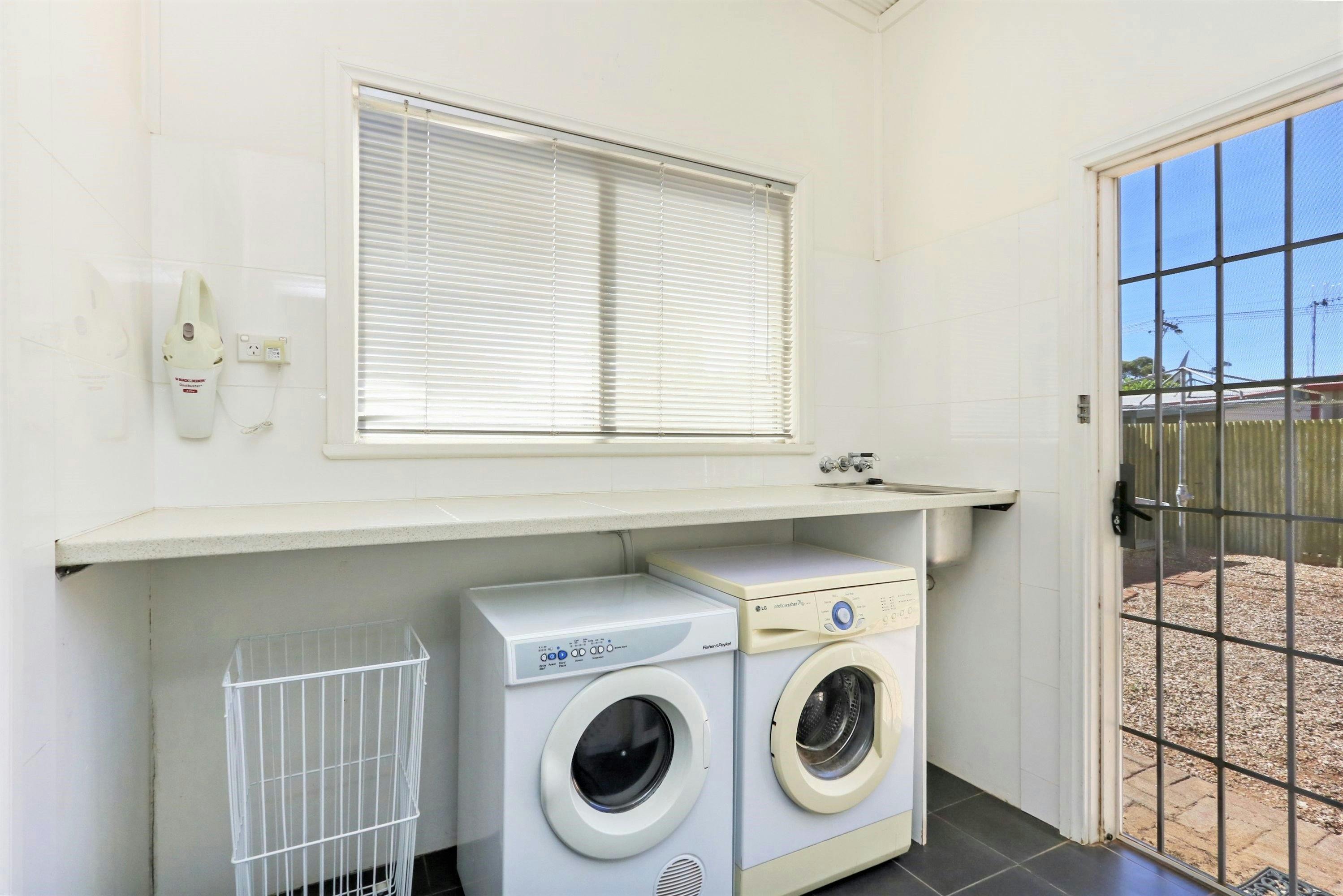 Full laundry facilities, including front-loading washing machine and dryer