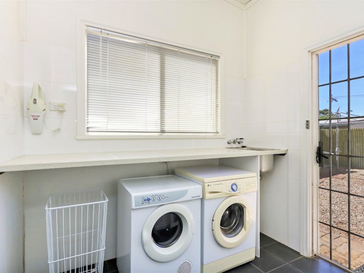 Full laundry facilities, including front-loading washing machine and dryer