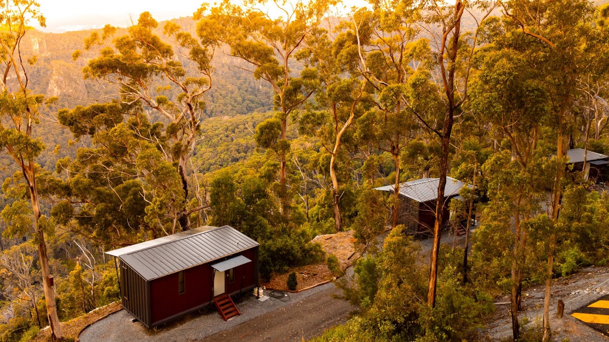 An aerial image showing the Tiny Wild Houses at Binna Burra as the sun sets