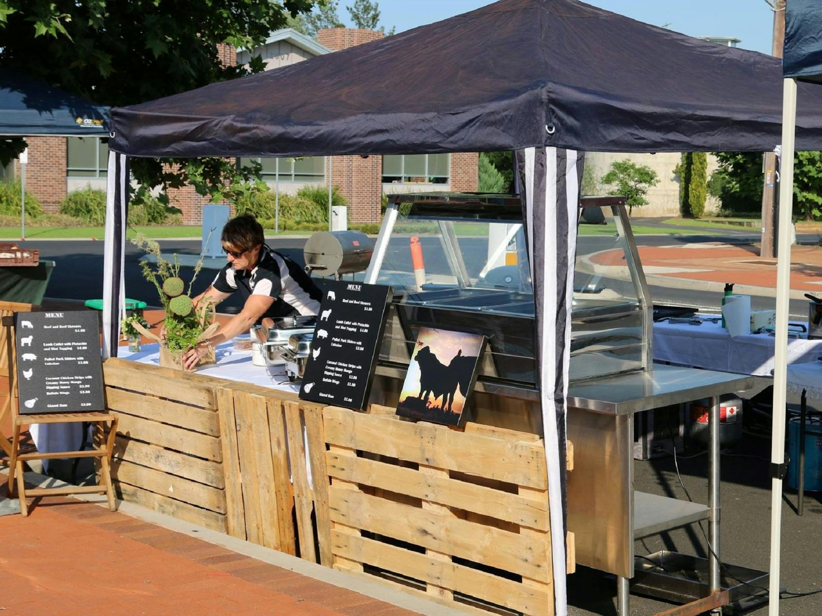 Lady standing behind market stall counter